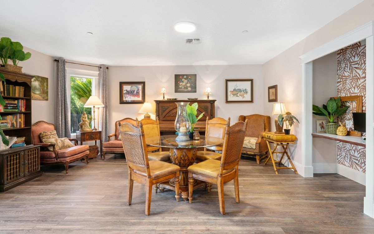 A cozy living and dining area with wooden furniture and tasteful decor.