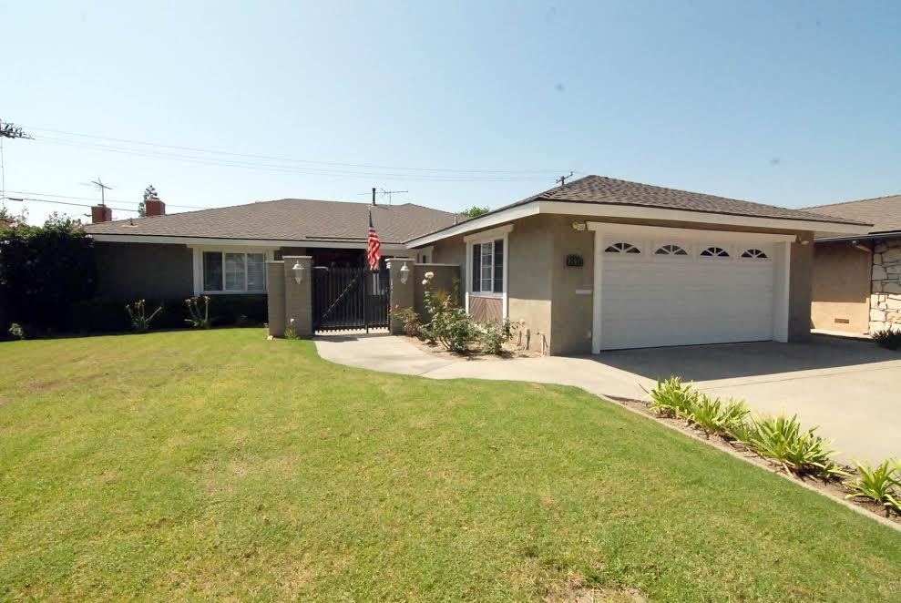 A suburban house with a neatly maintained lawn and attached garage.
