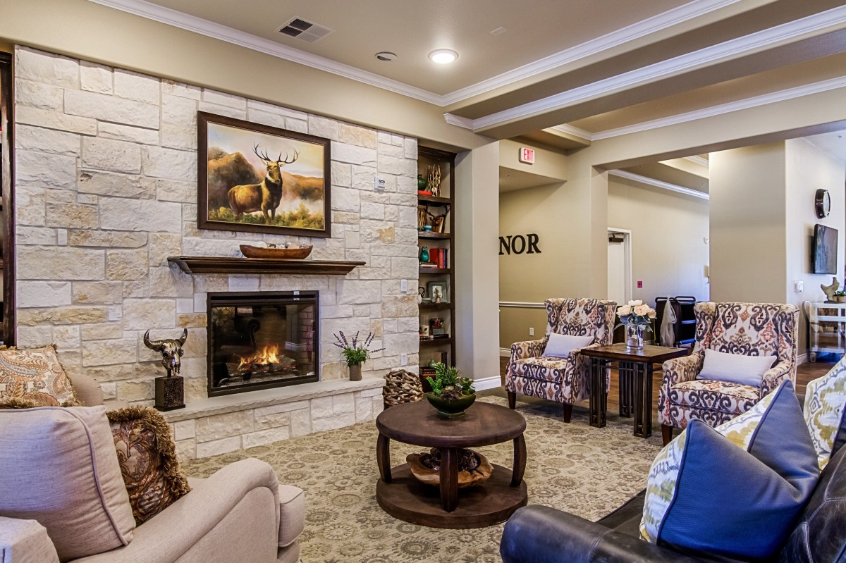 A cozy living room with a fireplace, comfortable seating, and stylish decor.