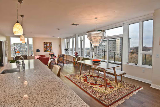 A stylish and modern apartment interior featuring a spacious living and dining area with stunning city views.