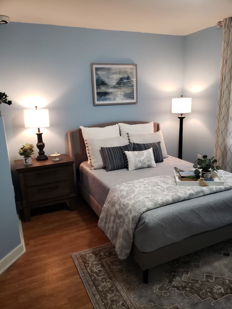 A cozy bedroom featuring soft lighting, elegant decor, and a neatly made bed.