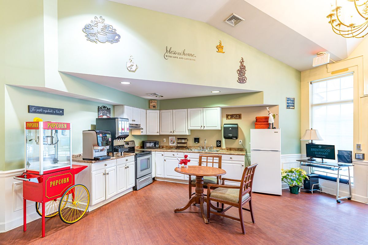A cozy kitchen with dining area featuring decorative elements and various appliances.