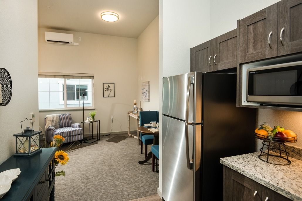 Modern apartment interior featuring a kitchen and living area with stylish furnishings.