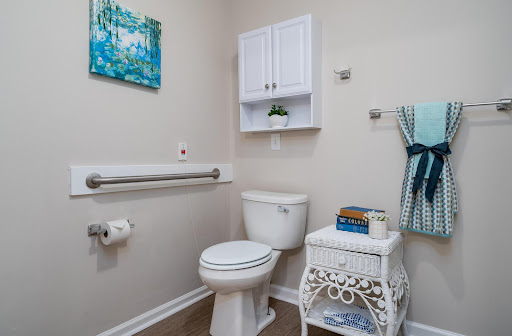 A clean and organized bathroom featuring essential amenities and decorative touches.
