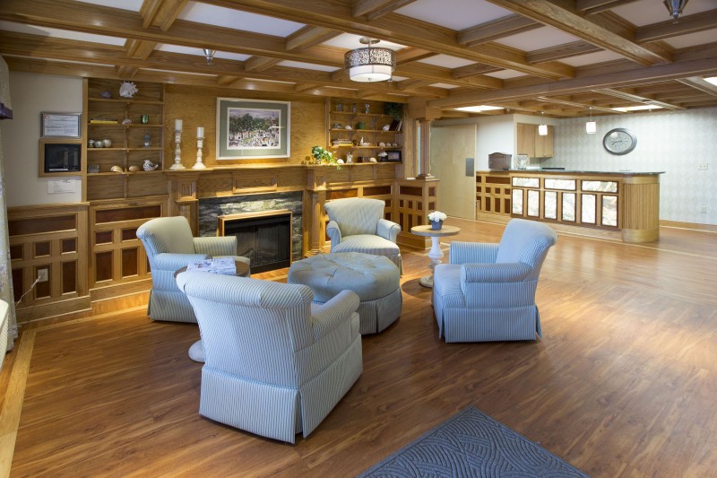 A cozy lobby seating area with comfortable chairs and a fireplace.