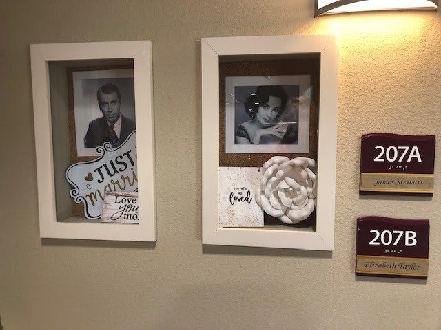 Vintage-style photo frames displayed in a hallway setting, likely part of hotel decor.
