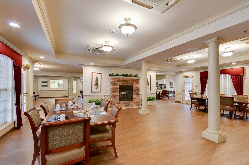 A spacious dining area with elegant furnishings and a cozy fireplace.