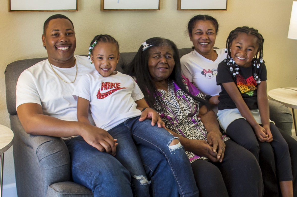 A joyful family sitting together on a couch.