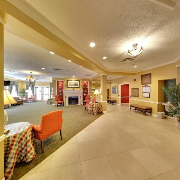 A spacious and well-decorated lobby area with seating and a fireplace.