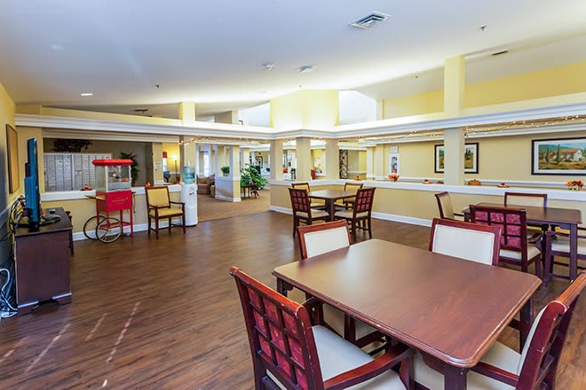 A spacious and well-lit dining area with tables and chairs arranged for comfort.