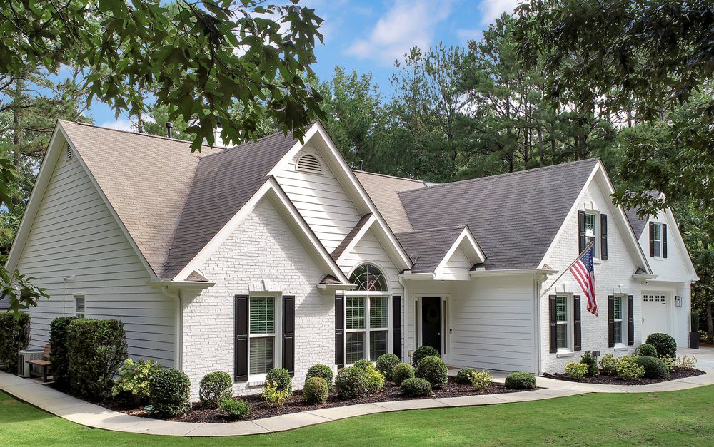 A beautiful suburban house with a well-maintained yard.