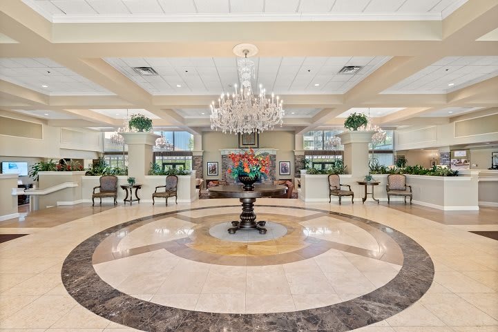 A luxurious hotel lobby featuring a grand chandelier and elegant seating arrangement.