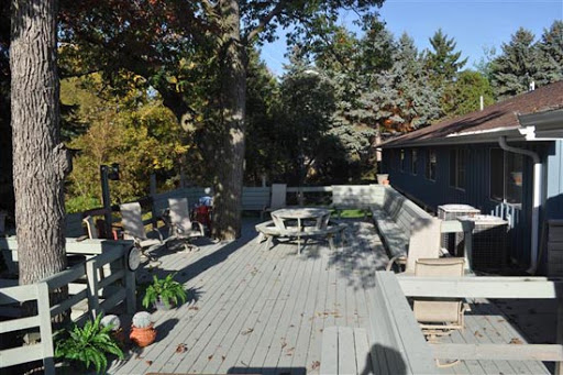 A spacious outdoor deck surrounded by trees, complete with patio furniture for relaxation.