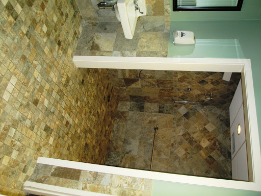 A modern bathroom featuring tiled floors and walls.
