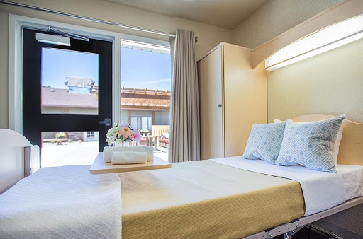 A bright and inviting bedroom with modern furnishings and a view outside.
