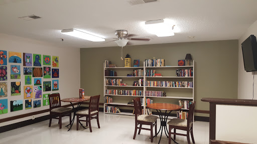 A cozy reading nook featuring bookshelves and tables for study.
