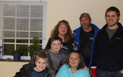 A joyful family gathering captured in a warm indoor setting.