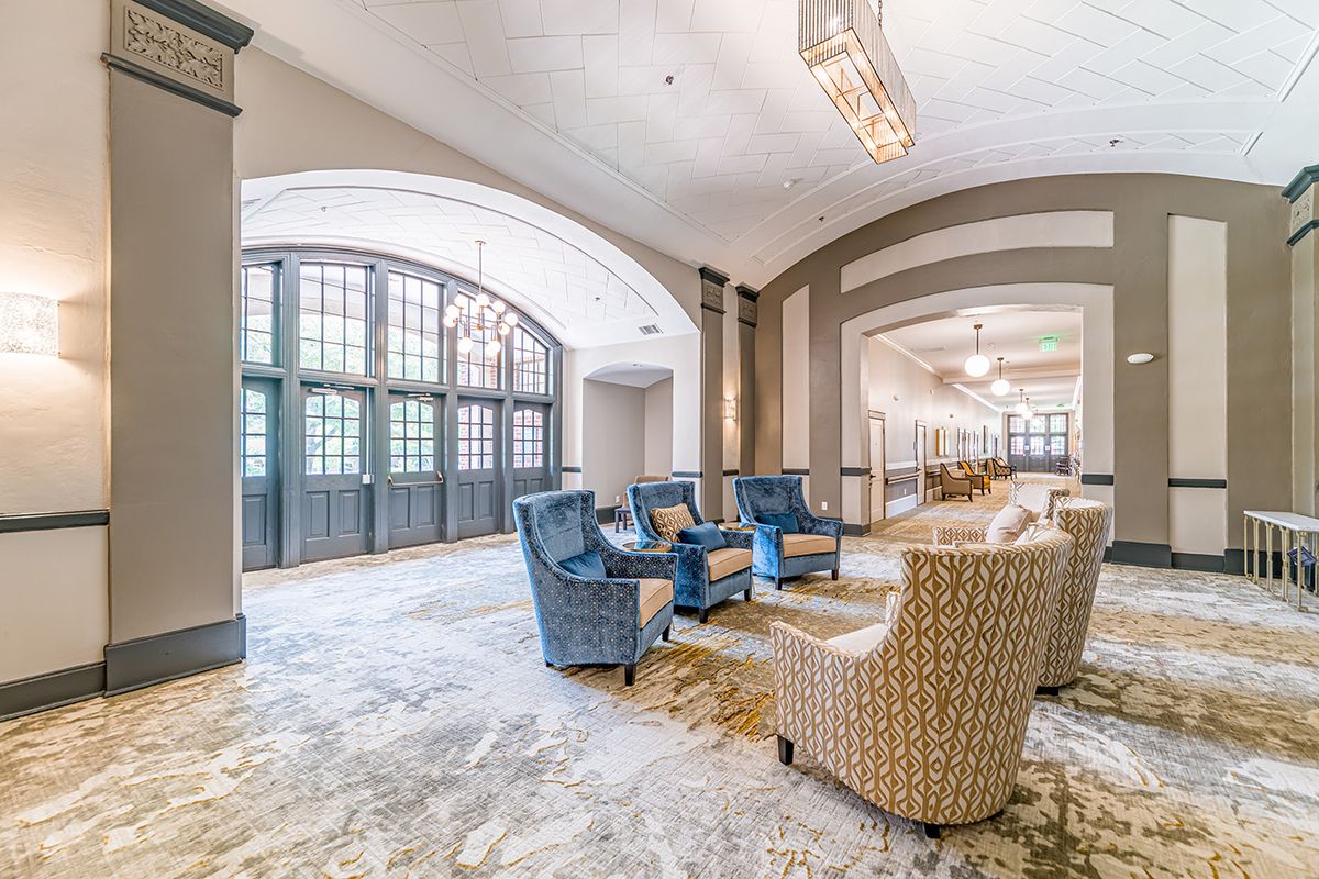 A spacious and elegantly designed lobby with comfortable seating arrangements.