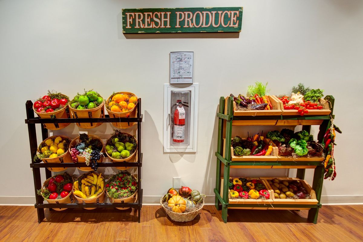 A vibrant display of fresh produce including fruits and vegetables arranged on shelves in a grocery store.