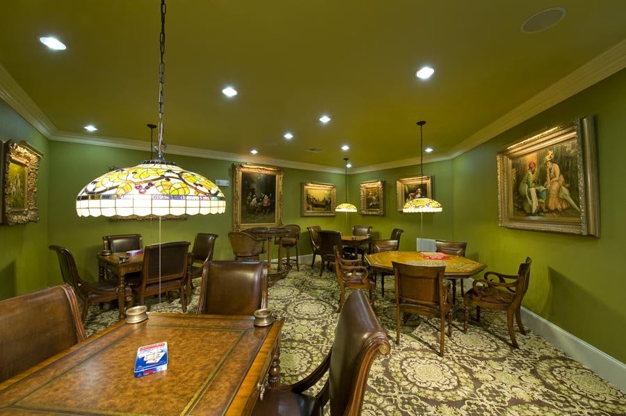 A cozy lounge area with elegant furniture and classic artwork on the walls.