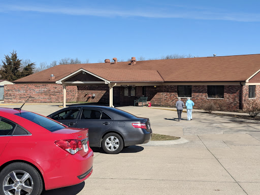 Healthcare workers outside a facility on a sunny day.