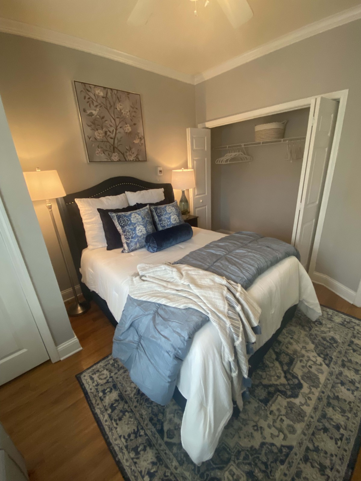 A cozy and well-decorated bedroom with blue and white bedding.