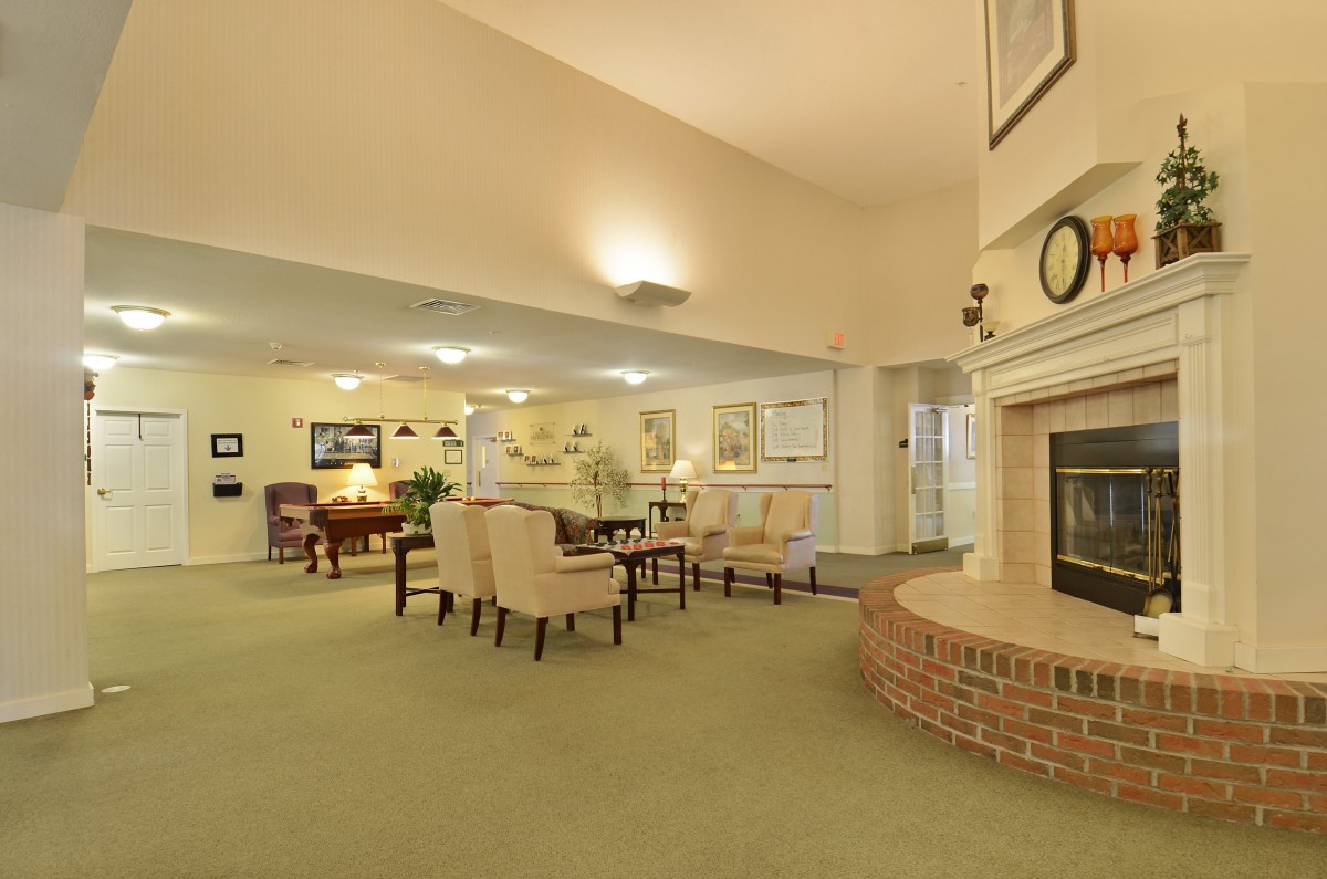 A cozy living room with comfortable seating and a brick fireplace.