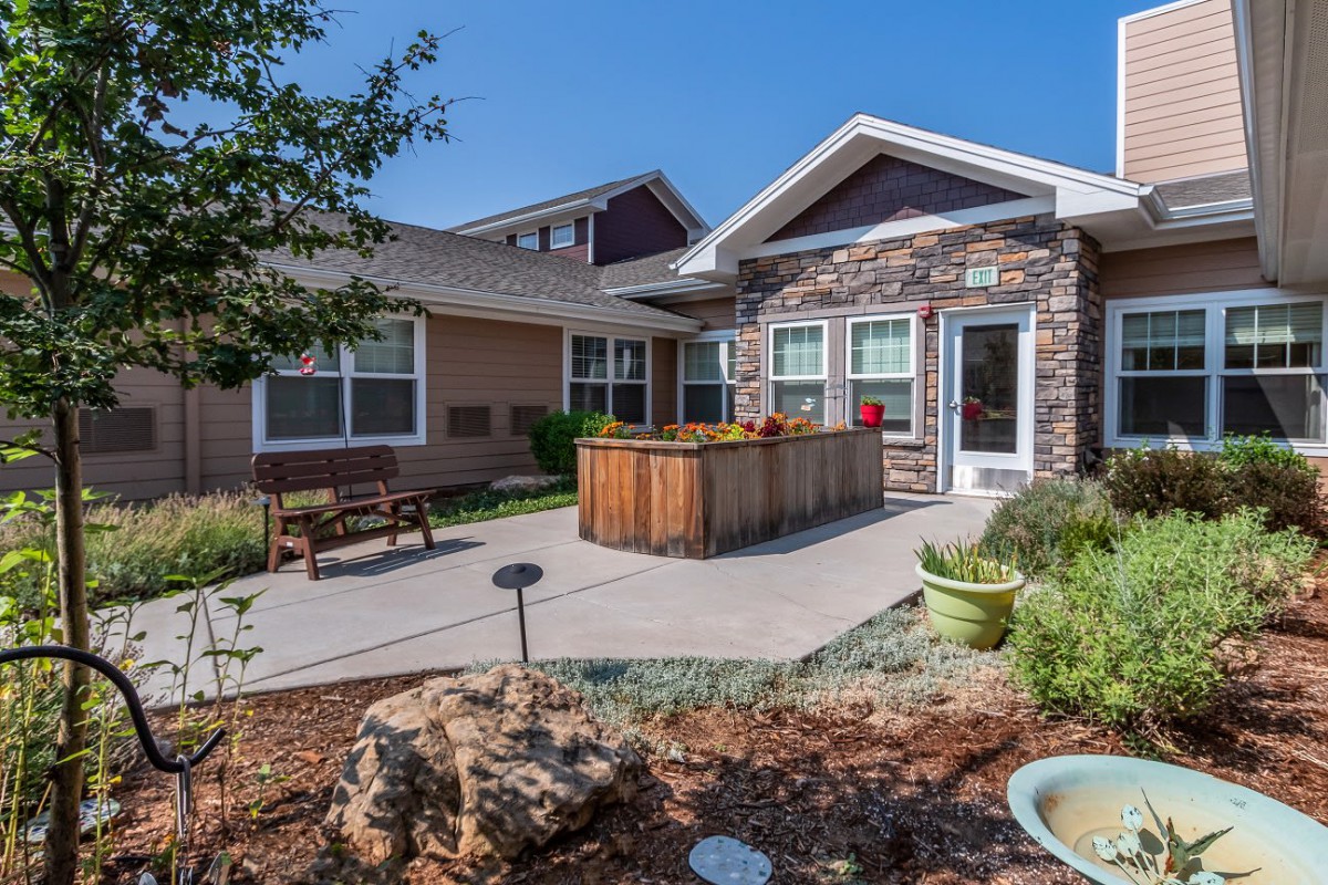 A charming house with a landscaped garden and patio area.