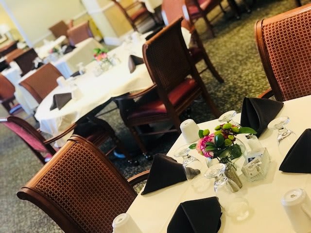 A well-arranged dining area with neatly set tables and elegant decorations.