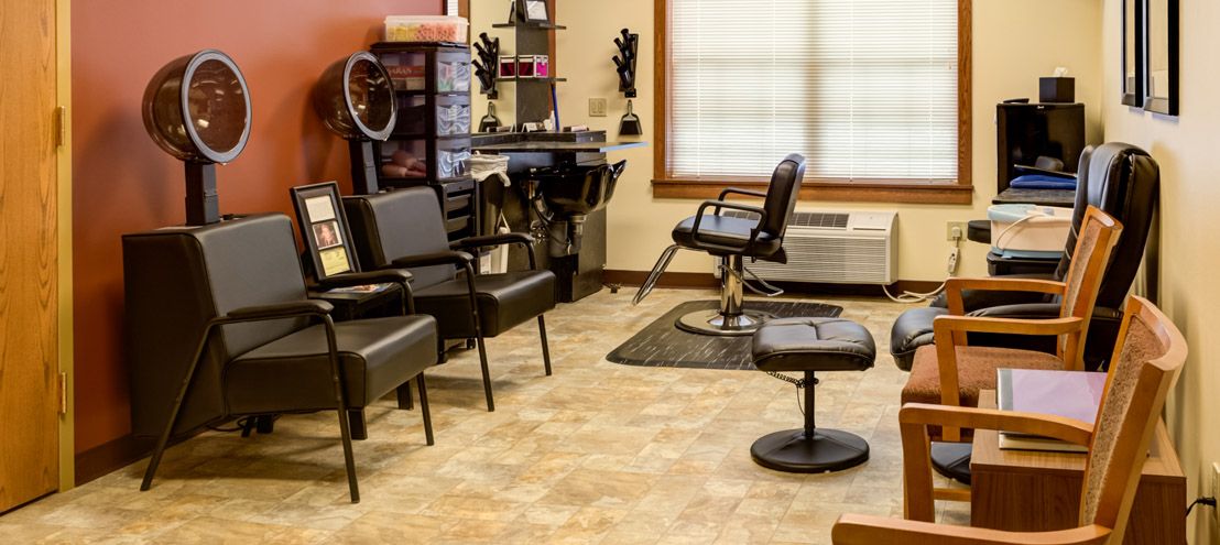 A well-organized hair salon interior with chairs and styling equipment.
