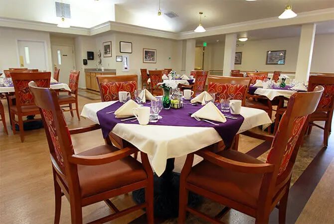 A well-set dining area with neatly arranged tables and chairs, ready for guests.