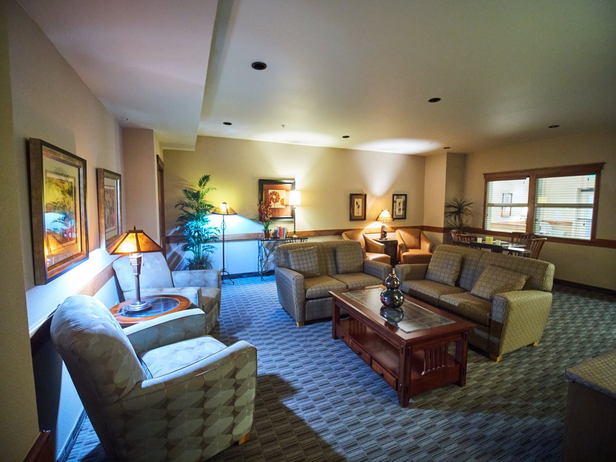 A cozy living room with comfortable sofas and warm lighting.