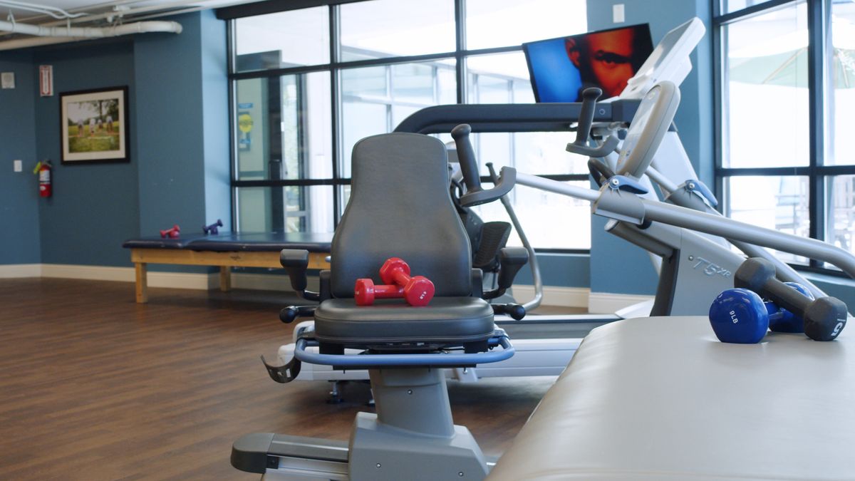 A modern gym with exercise equipment and dumbbells ready for a workout session.