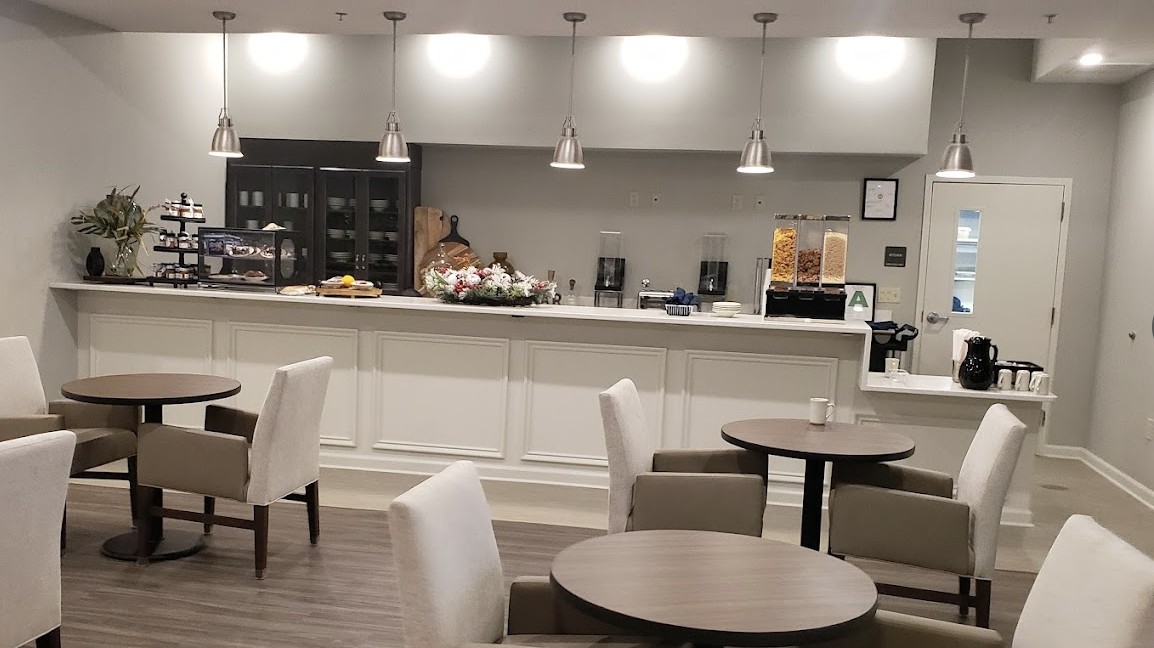 A modern cafe interior with a seating area and a counter.