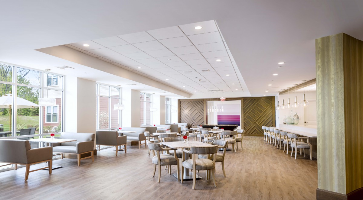 A modern and spacious dining and lounge area with tables and chairs.