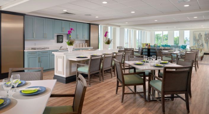 A modern dining area with neatly arranged tables and chairs, featuring a stylish interior design.