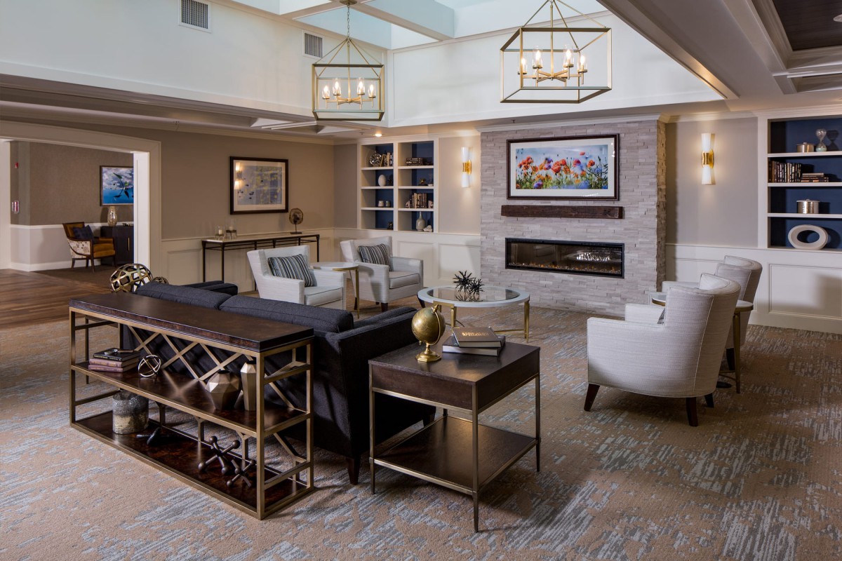 A modern living room with stylish furniture and a cozy fireplace.