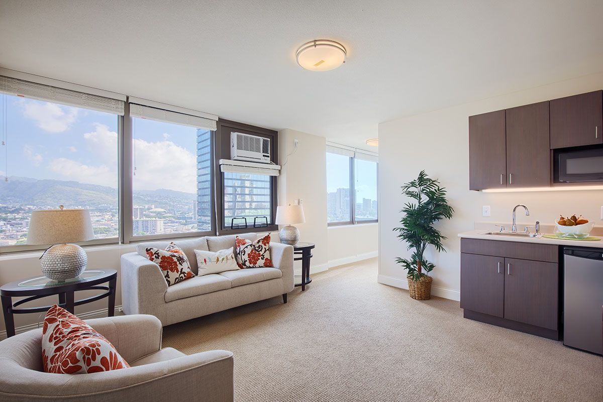 A modern apartment living room with a city view and cozy furnishings.