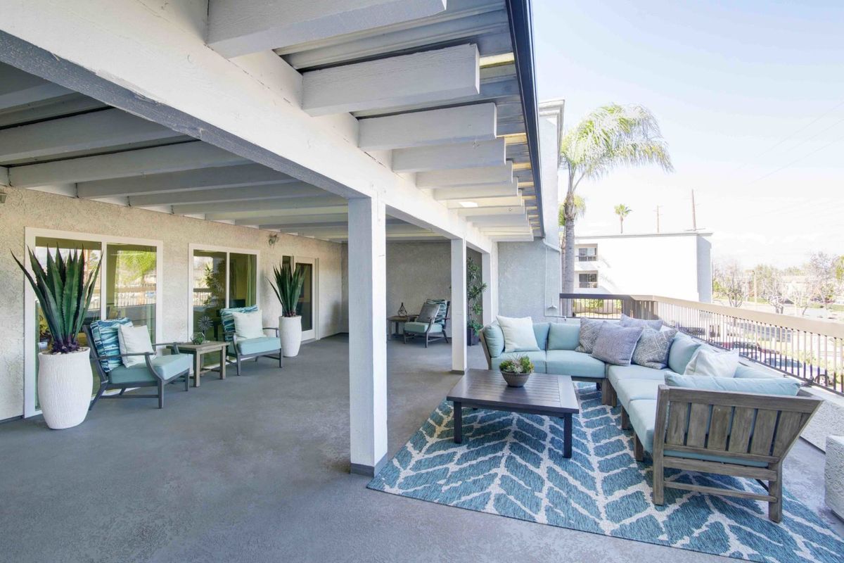 A modern outdoor patio featuring comfortable seating and stylish decor.