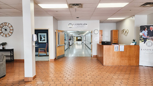A view of the interior of a hospital, showcasing the reception area and a long corridor leading to patient rooms.
