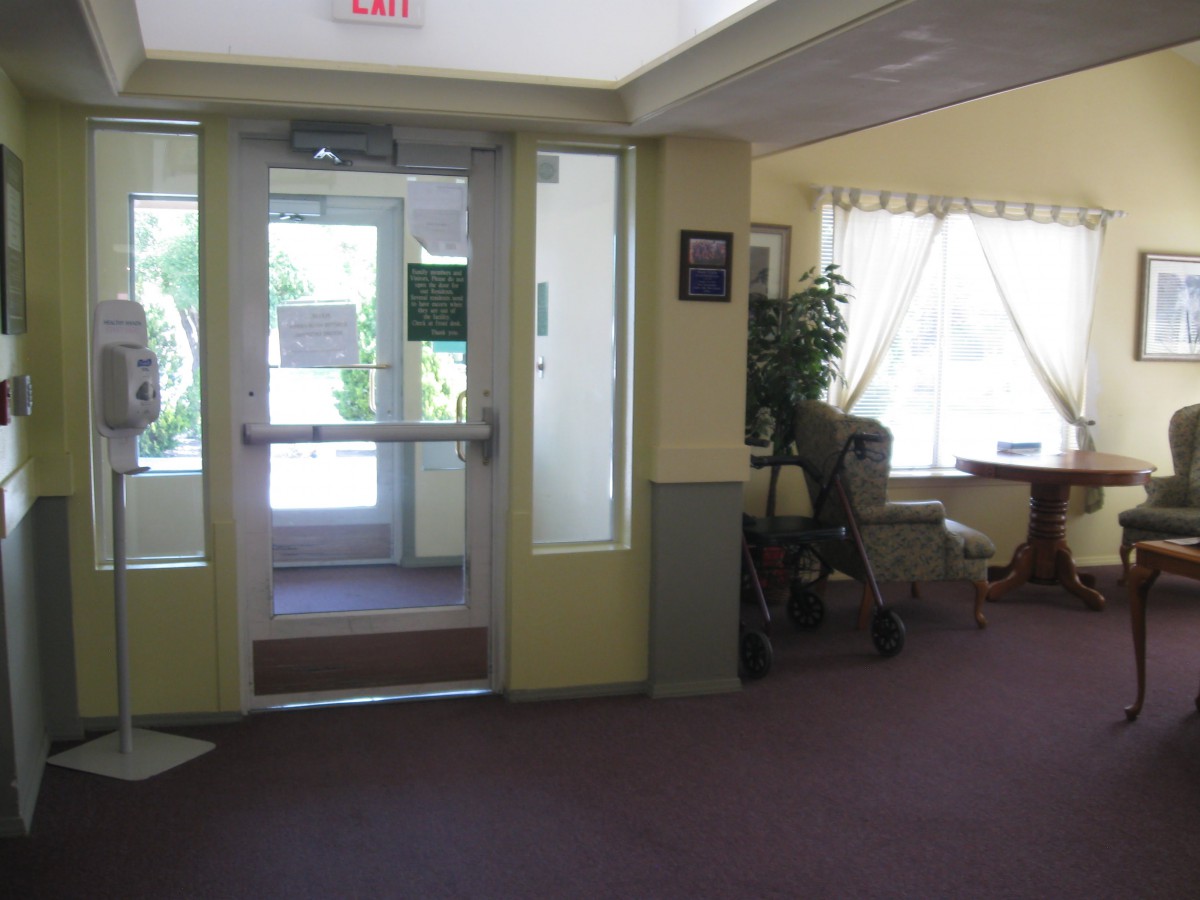 A view of an interior entrance area with a door, large window, and seating.