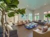 A modern and bright living room with stylish furniture and large windows.