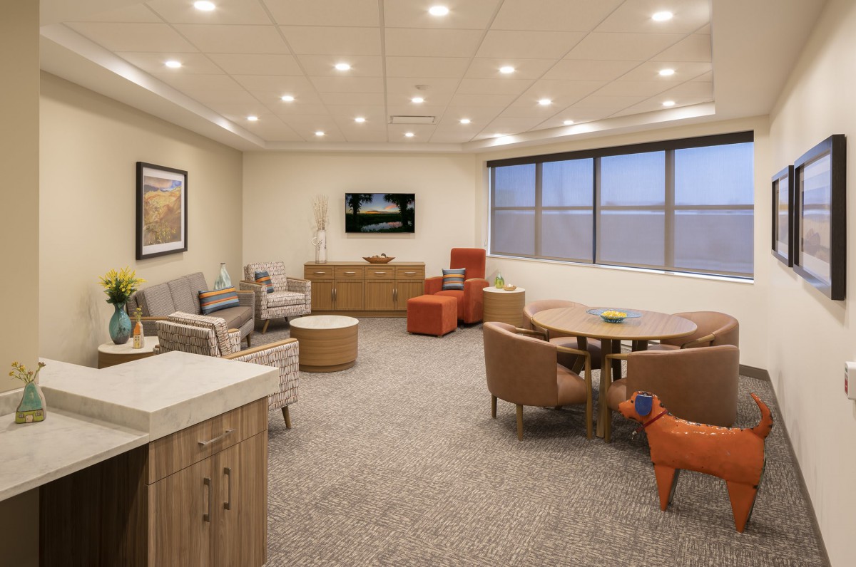 A modern office lounge with comfortable seating and minimalist decor.