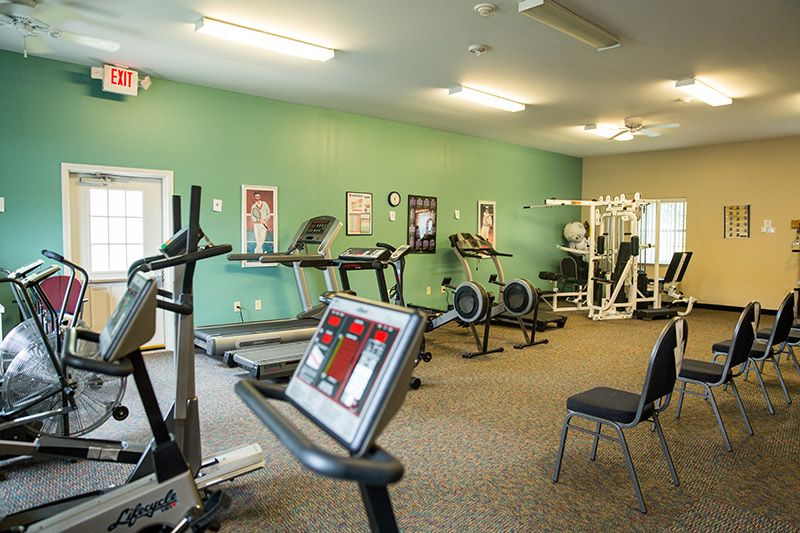 A well-equipped gym featuring treadmills, stationary bikes, and weight machines.