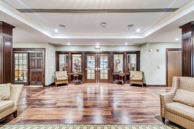 Spacious lobby with elegant wood flooring and comfortable seating.