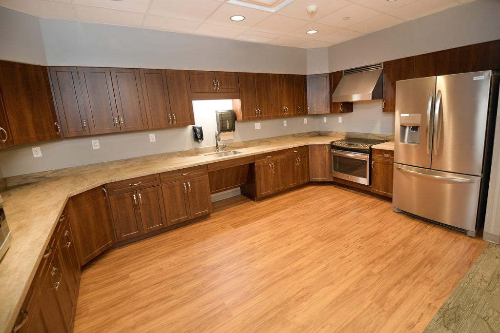 A modern kitchen with wooden cabinets and stainless steel appliances.