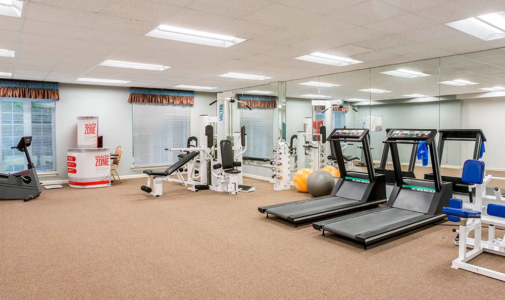 A well-equipped gym with treadmills and weight machines, offering a space for fitness and exercise.