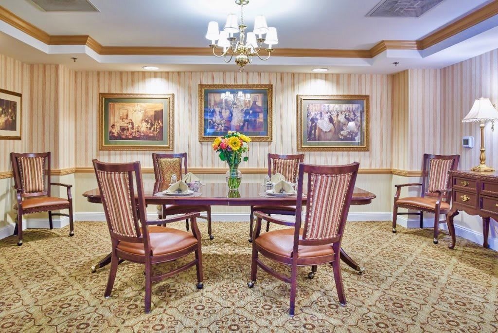 A cozy dining room with elegant decor and a chandelier.