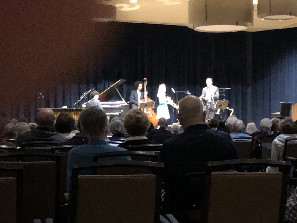 A live concert with musicians performing on stage in front of an audience.