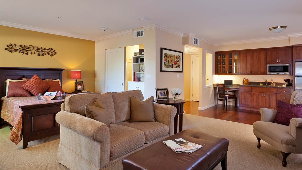 A cozy living room with a sofa and coffee table, featuring warm decor and inviting ambiance.